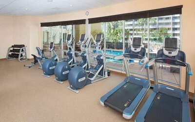 Fitness facility with a view of the pool at Hilton Garden Inn Burbank Downtown.
