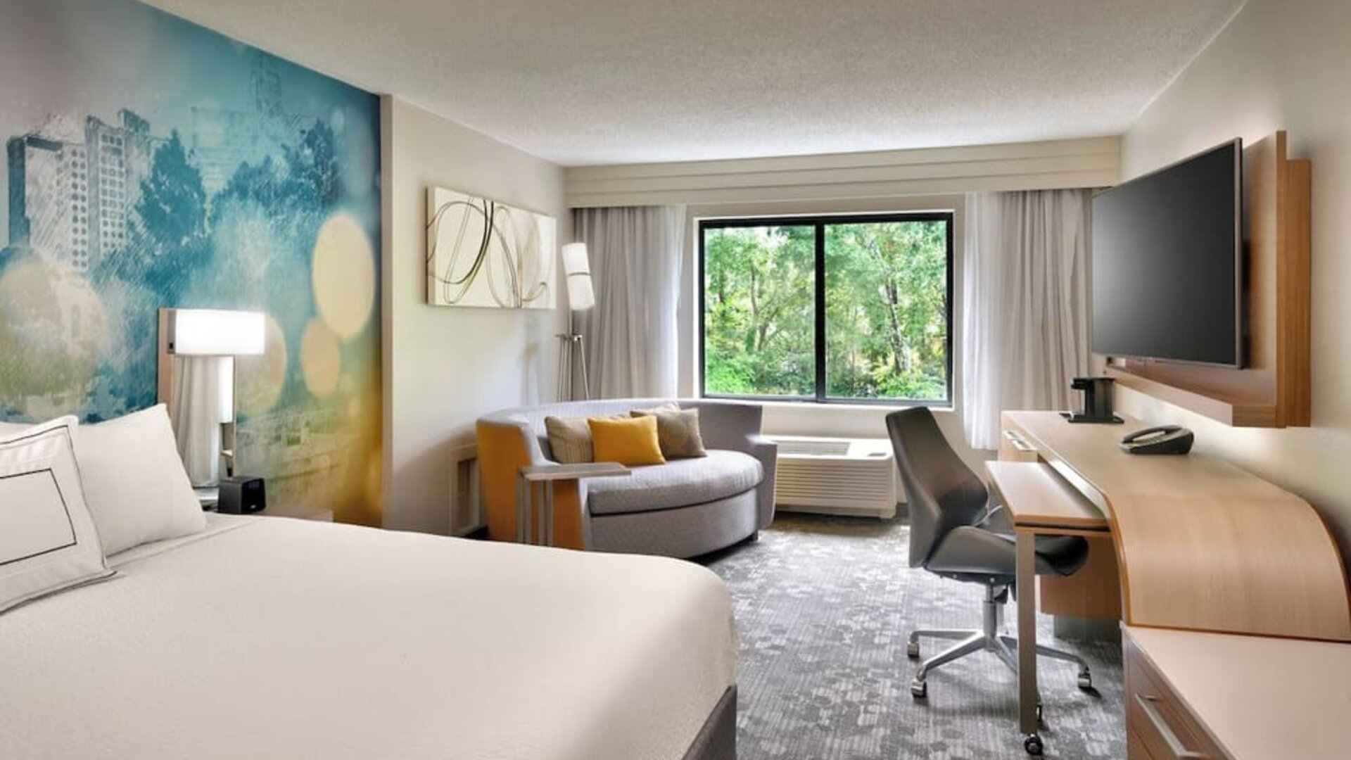 Day use room with sofa and work desk at Courtyard By Marriott Charlotte Airport/Billy Graham Parkway.