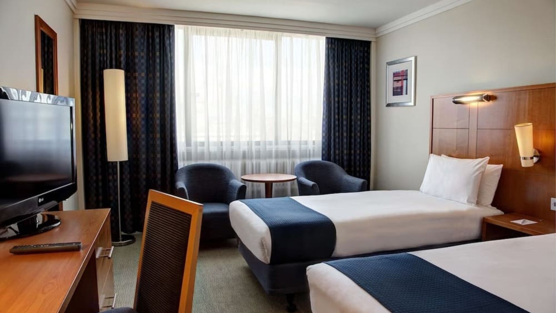 Day use twin room with work desk and lounge seating at Best Western London Heathrow Ariel Hotel.