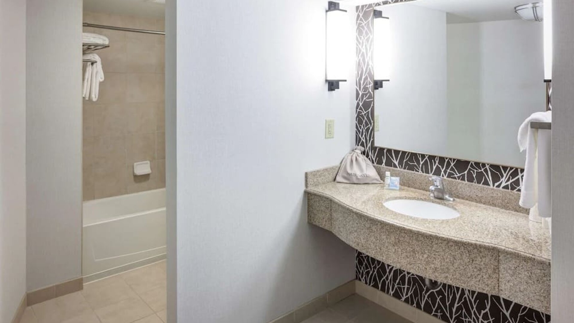 Guest bathroom with shower and tub at Hilton Garden Inn Nashville Vanderbilt.