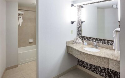 Guest bathroom with shower and tub at Hilton Garden Inn Nashville Vanderbilt.