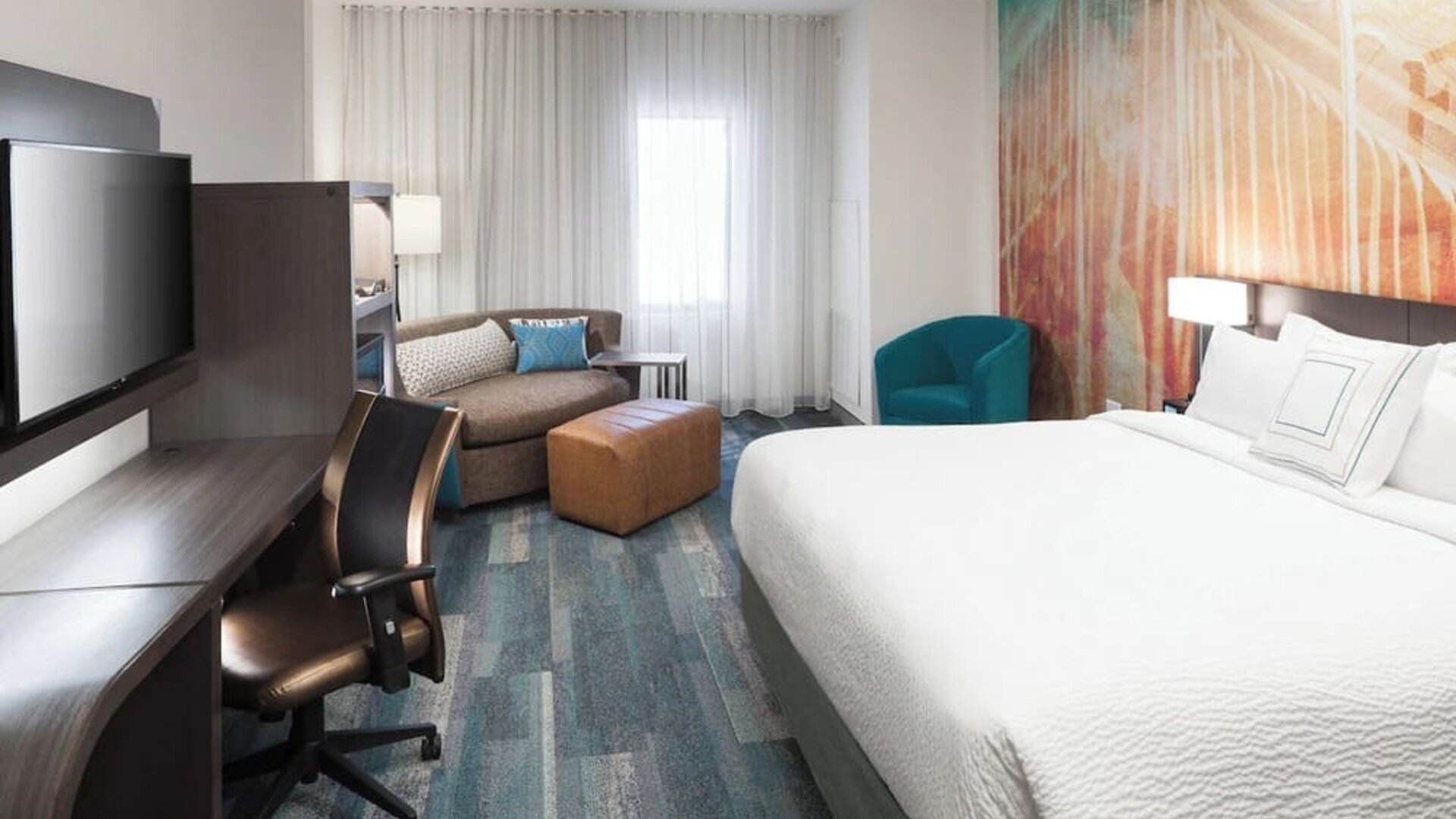 Day use room with work desk and sofa at Courtyard By Marriott Fort Worth Historic Stockyards.