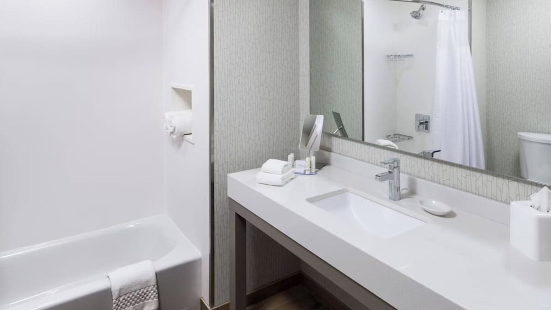 Guest bathroom with shower and tub at Courtyard By Marriott Fort Worth Historic Stockyards.