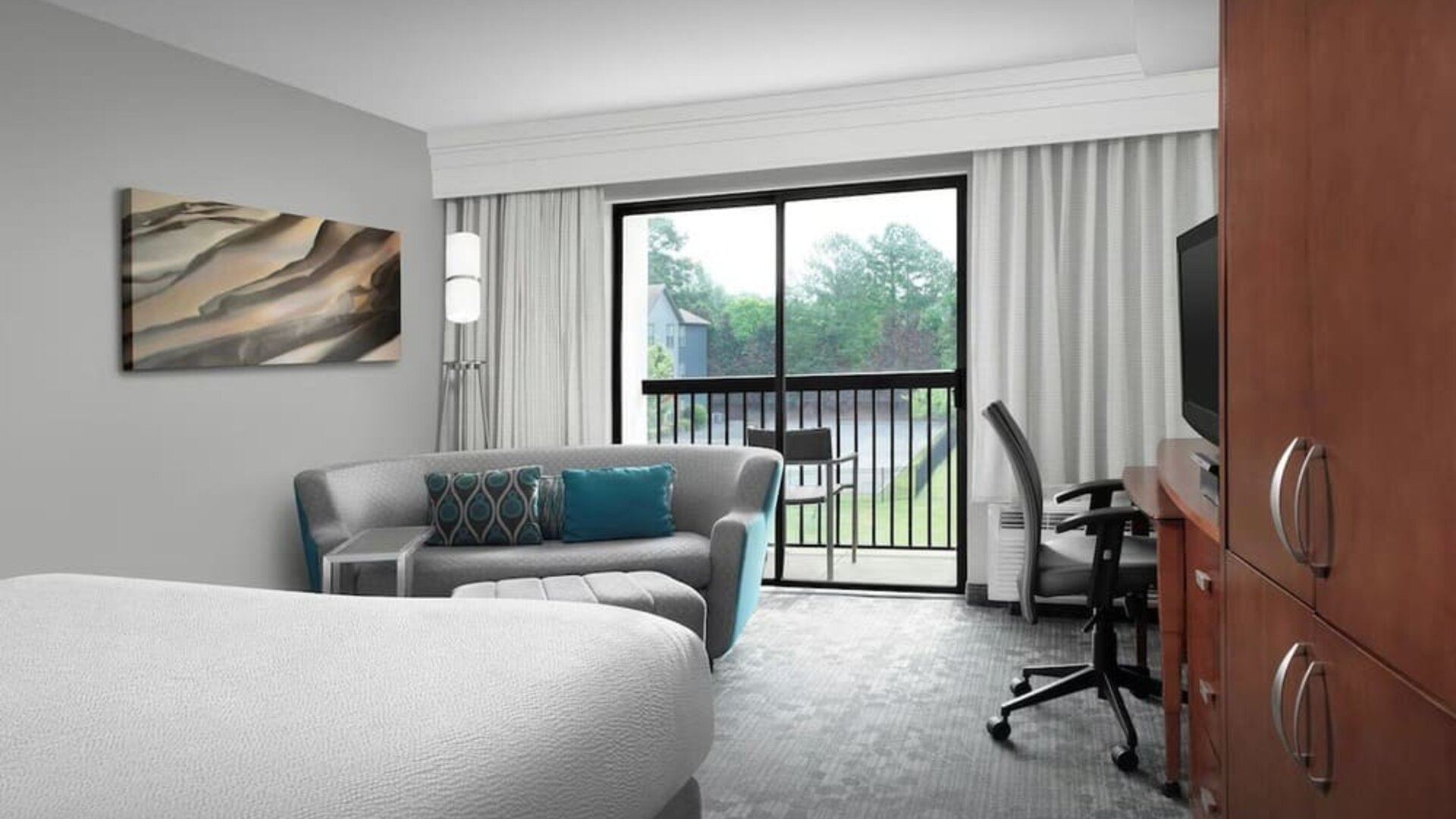 Day use room with work desk and balcony at Courtyard By Marriott Hattiesburg.