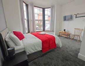 Bright and spacious day use room with work desk at Campbell Guest House Hotel.