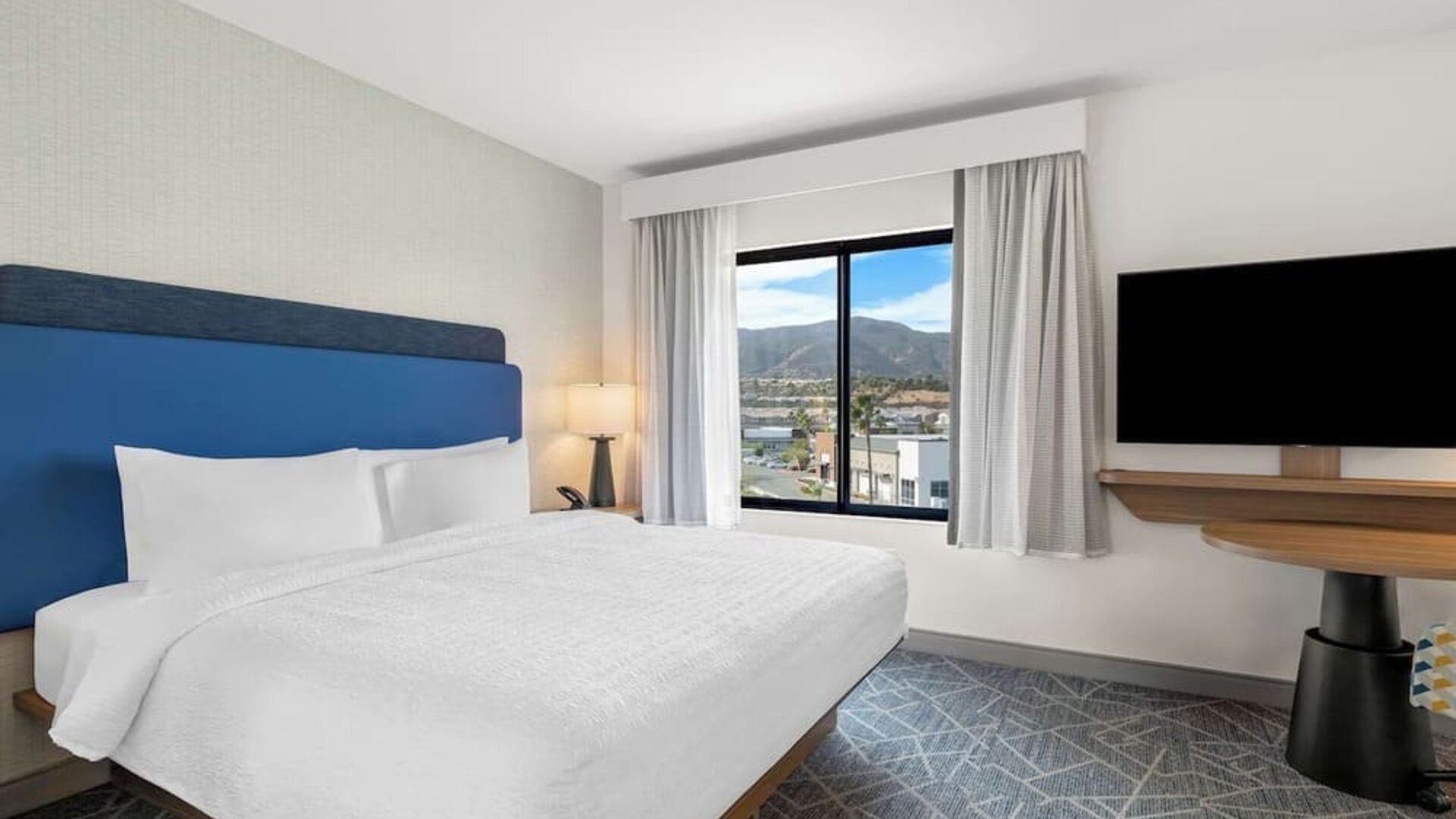 King room with TV at Hampton Inn & Suites Corona, CA.