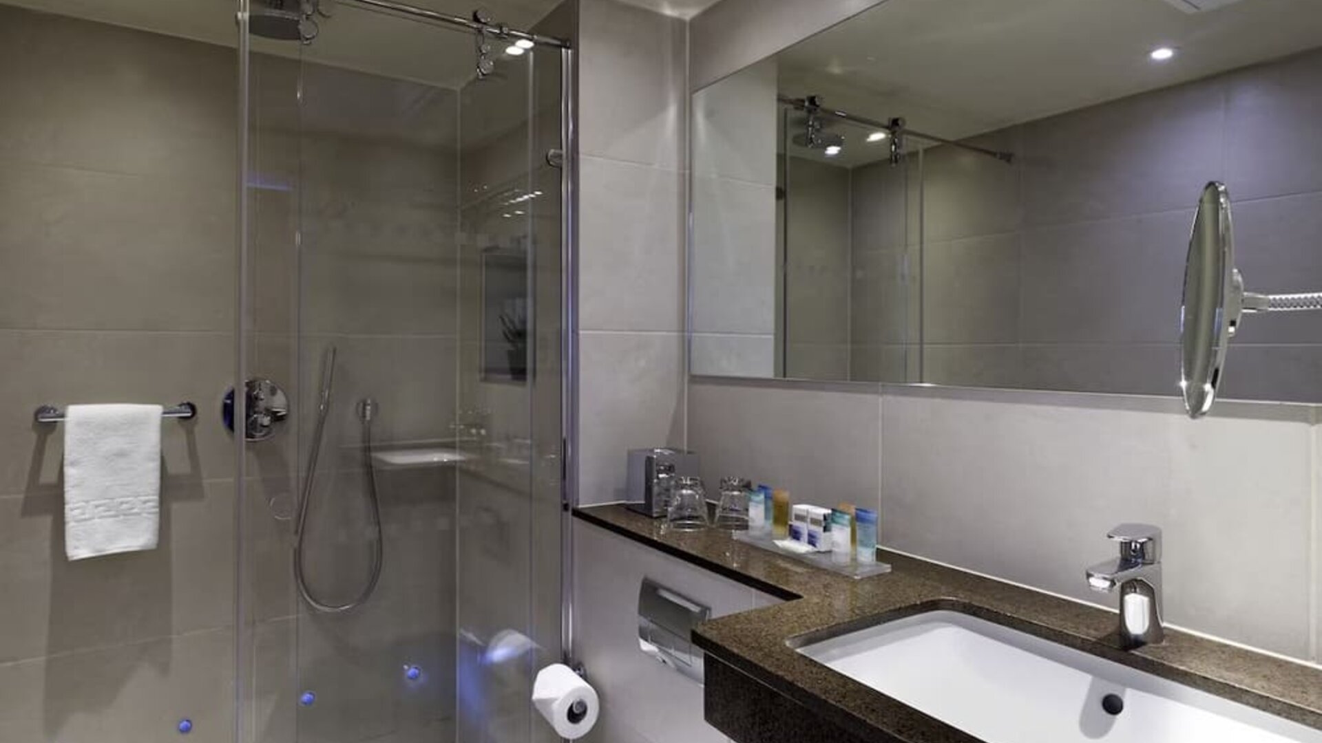 Private guest bathroom with shower and free toiletries at Blakemore Hyde Park Hotel.
