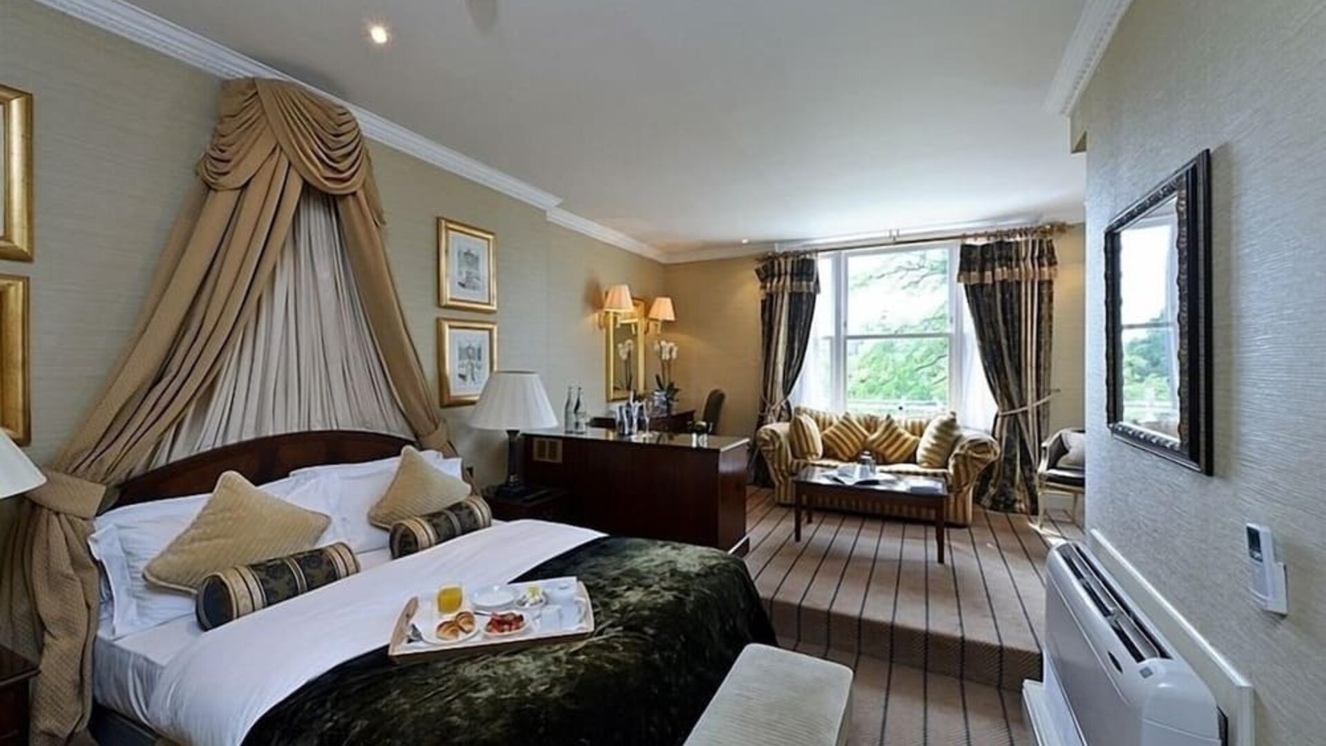 Junior suite with work desk and lounge area at The Colonnade Hotel.