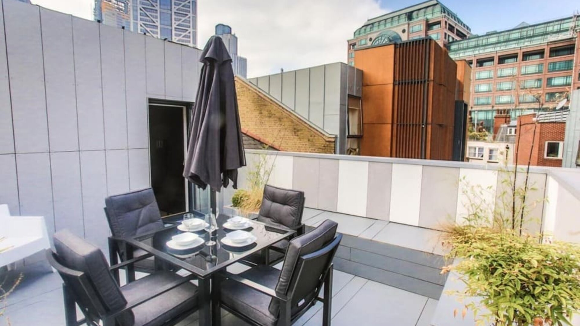 Roof terrace with seating at Room Home Stay.