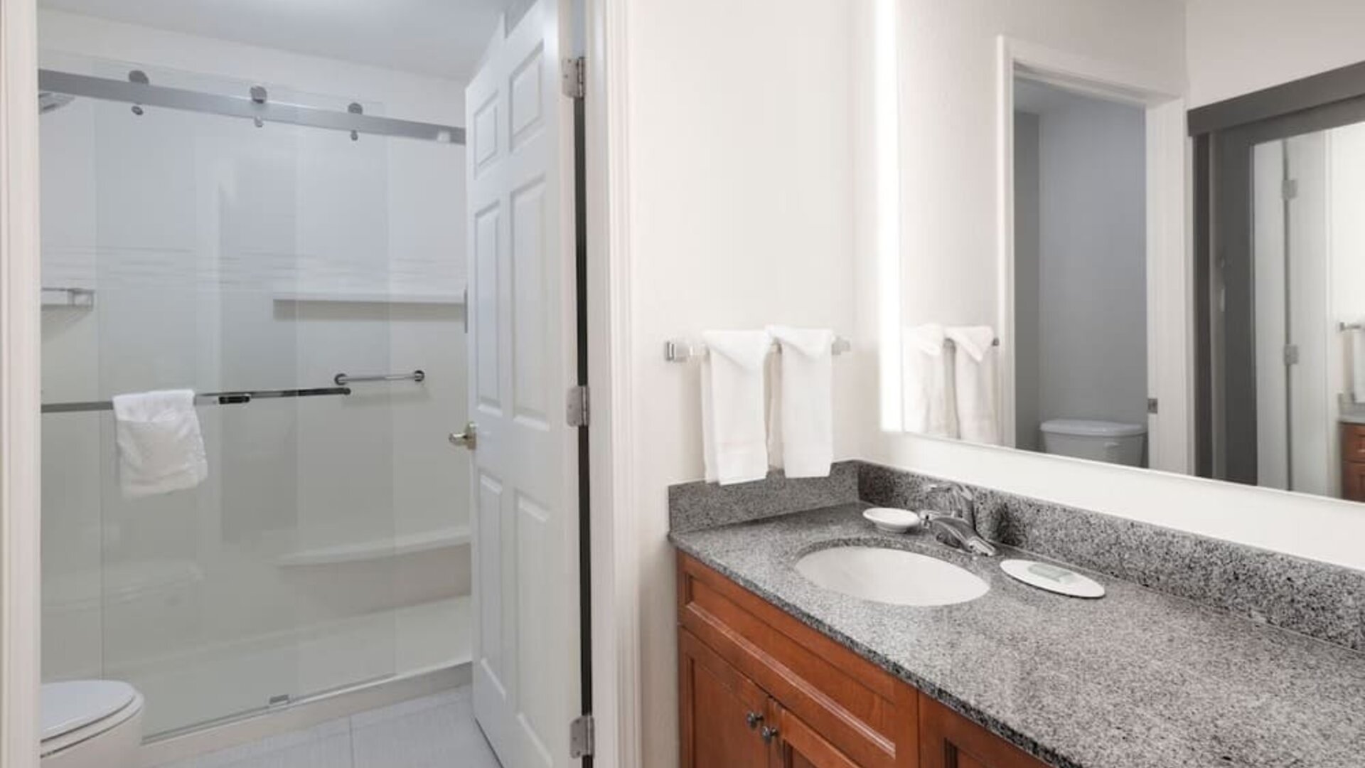 Guest bathroom with shower at Residence Inn By Marriott Bentonville Rogers.