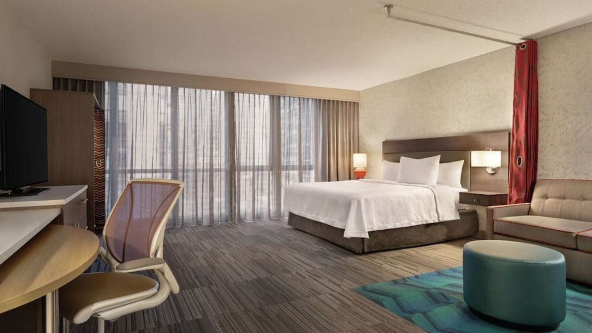 Spacious day use room with work desk and sofa at Home2 Suites By Hilton Chicago River North.
