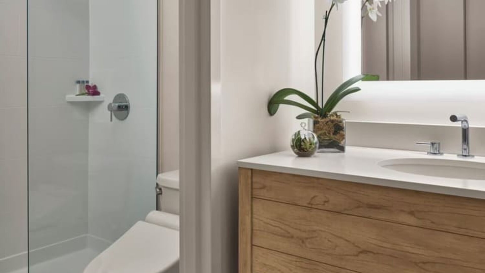 Guest bathroom with shower at Alohilani Resort Waikiki Beach.