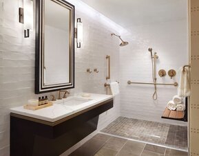 Guest bathroom with shower at The Plaza Pioneer Park, El Paso.