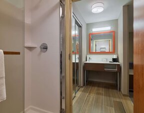 Guest bathroom with shower at Hampton Inn & Suites Providence/Smithfield.