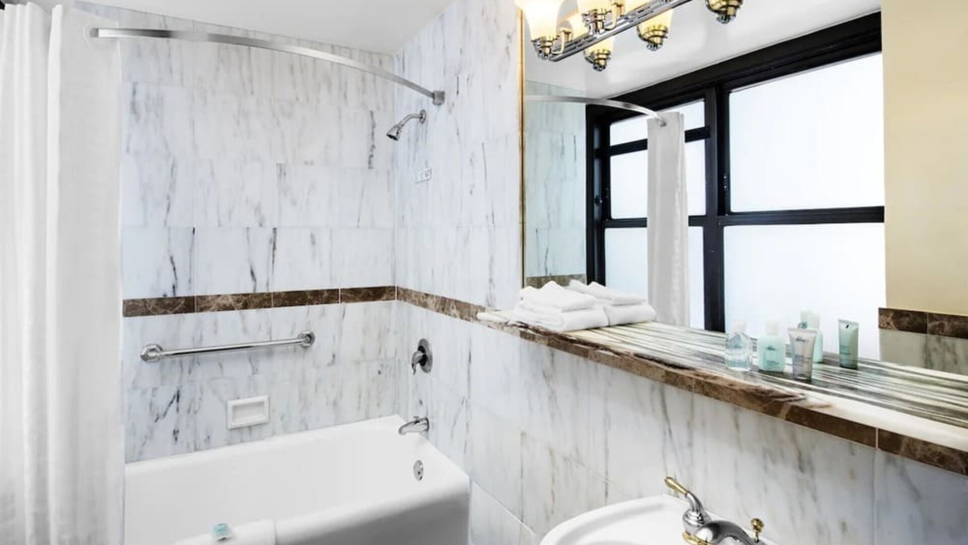 Guest bathroom with shower at The New Yorker Hotel, A Wyndham Hotel.