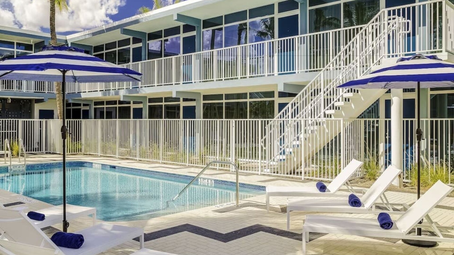 Refreshing outdoor pool and sun loungers at Plunge Beach Resort.