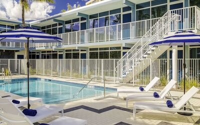 Refreshing outdoor pool and sun loungers at Plunge Beach Resort.