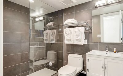 Guest bathroom with shower at Plunge Beach Resort.