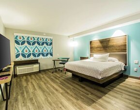 Cozy king-sized bed with TV at Tru By Hilton Bowling Green.