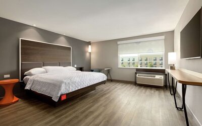 Spacious delux king bed with work desk at Tru By Hilton Wichita Northeast.
