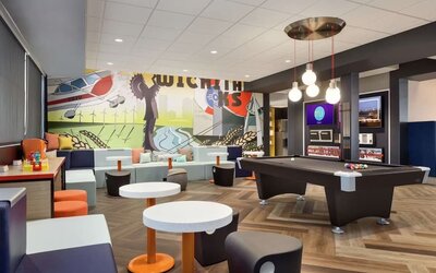 Lobby, coworking lounge and billiards table at Tru By Hilton Wichita Northeast.
