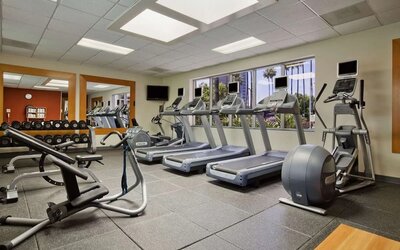Fully equipped fitness center at Embassy Suites By Hilton San Diego-La Jolla.