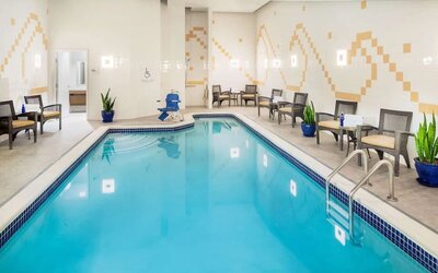 Indoor pool with lounge chairs at Hilton Garden Inn Washington DC Downtown.