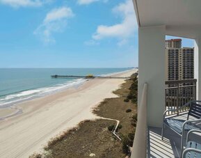 Balcony from day use room overlooking the ocean at Embassy Suites By Hilton Myrtle Beach Oceanfront Resort.