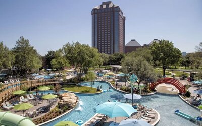 Lazy river, waterslide, and sun loungers available around the outdoor pool at Hilton Anatole.