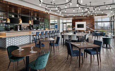 Dining area with natural light perfect for coworking at Hilton Garden Inn Camden Waterfront Philadelphia.