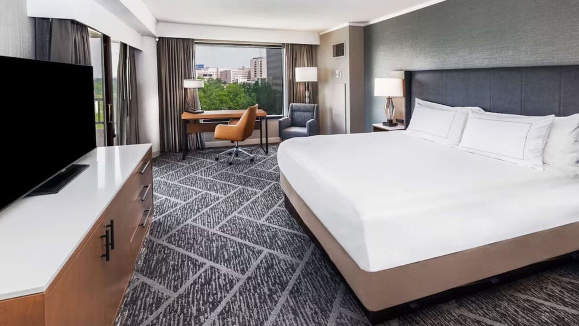 Day use room with work desk and natural light at DoubleTree By Hilton Tulsa - Warren Place.