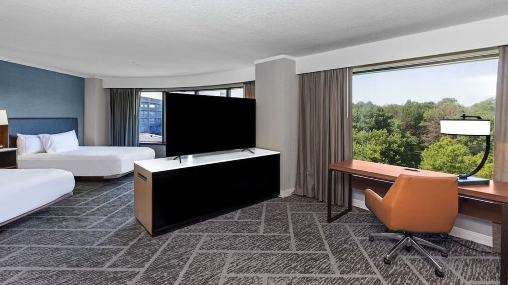 Two queen beds in a spacious day use room with work desk at DoubleTree By Hilton Tulsa - Warren Place.