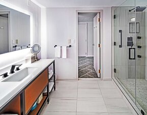 Guest bathroom with shower at DoubleTree By Hilton Tulsa - Warren Place.
