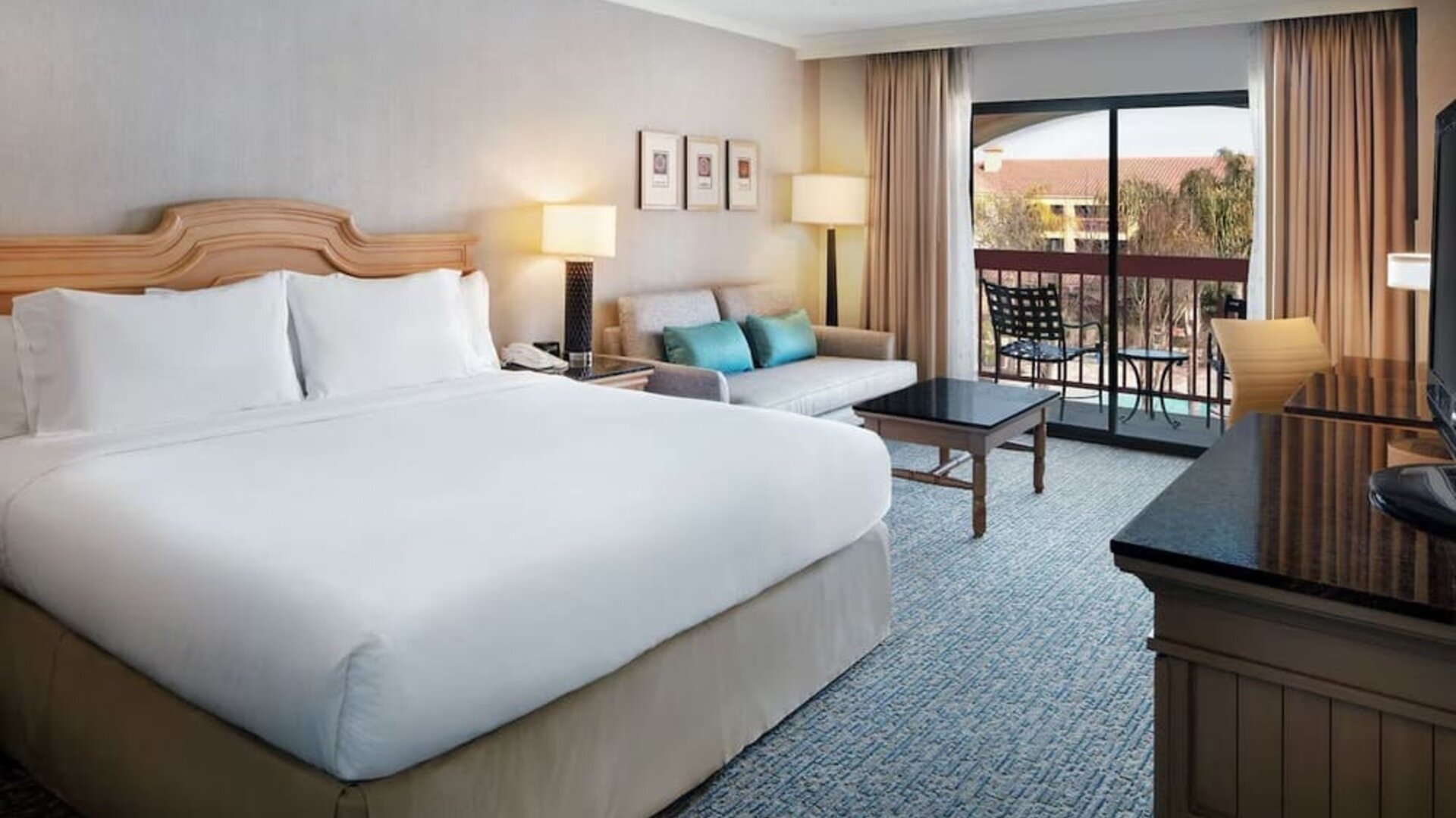 Day use room with work desk, sofa and balcony at DoubleTree By Hilton Sonoma Wine Country.
