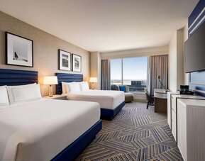 Day use room with two beds and workdesk at Hilton BNA Nashville Airport Terminal.
