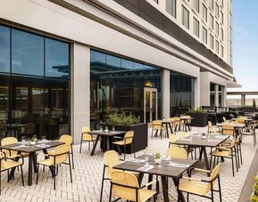 Hotel terrace with seating at Hilton BNA Nashville Airport Terminal.

