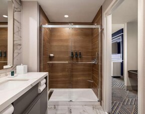 Private guest bathroom with shower at Hilton BNA Nashville Airport Terminal.
