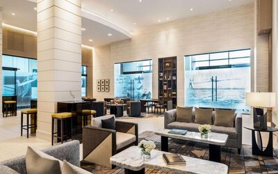 Hotel lobby with comfortable seating at Hilton BNA Nashville Airport Terminal.
