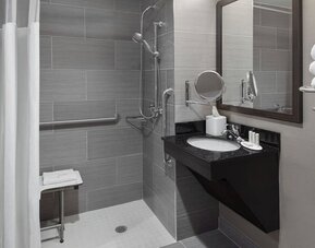 Ptivate guest bathroom with shower at Fairfield Inn & Suites By Marriott New York Staten Island.