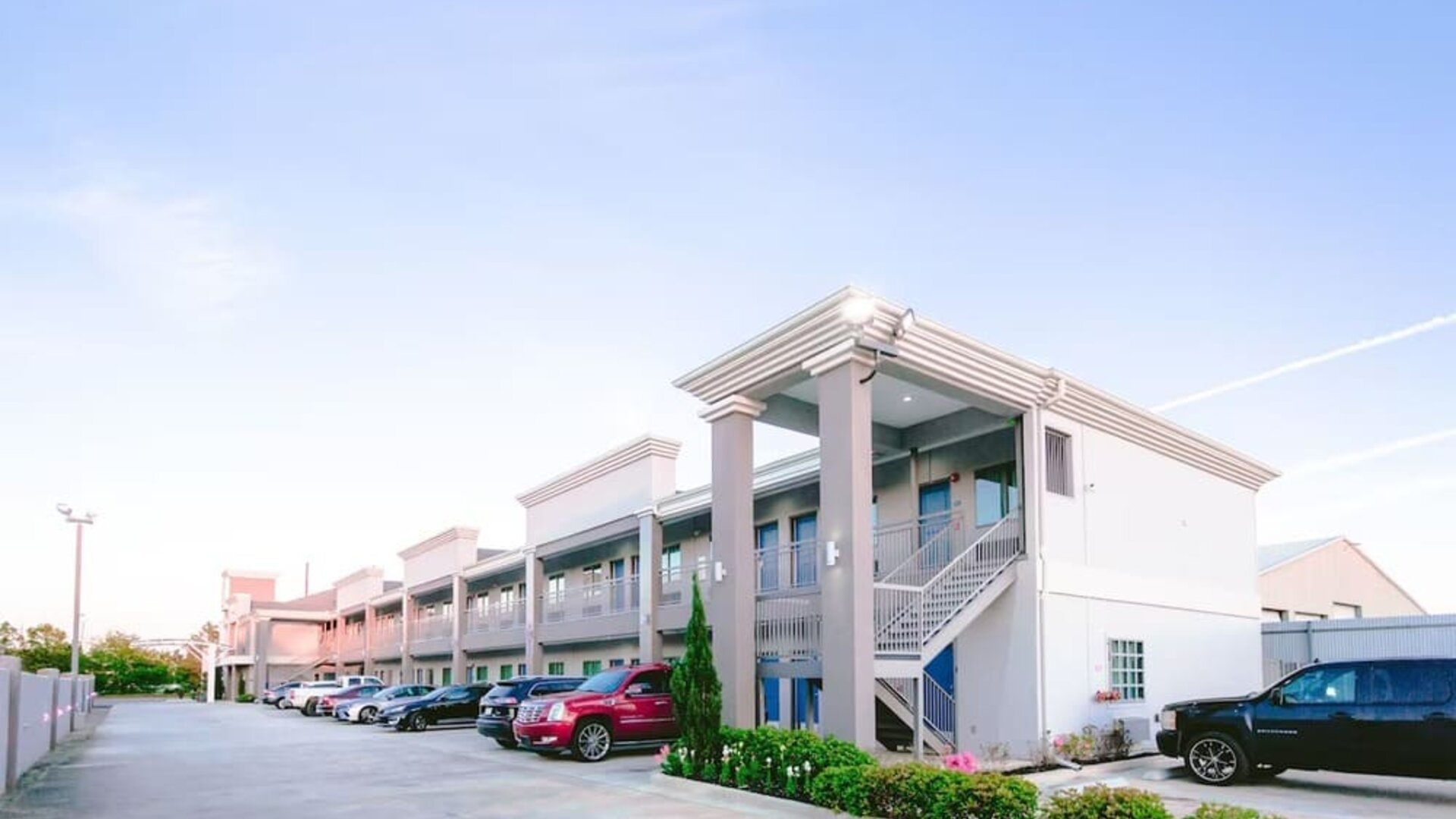 Hotel exterior and parking area at Express Inn - Spring.