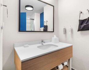 Private guest bathroom with shower and free toiletries at Spark By Hilton Pearland.