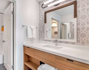Private guest bathroom with shower and free toiletries at Sonesta ES Suites San Antonio Downtown Alamo Plaza.