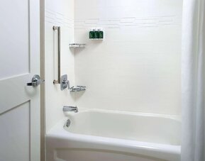 Private guest bathroom with tub and free toiletries at Sonesta ES Suites Raleigh Cary.