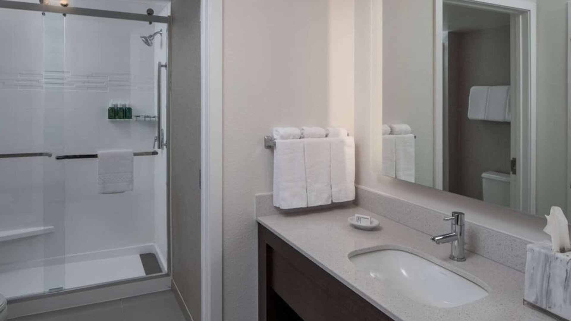 Private guest bathroom with shower and free toiletries at Sonesta ES Suites Fairfax Fair Lakes.