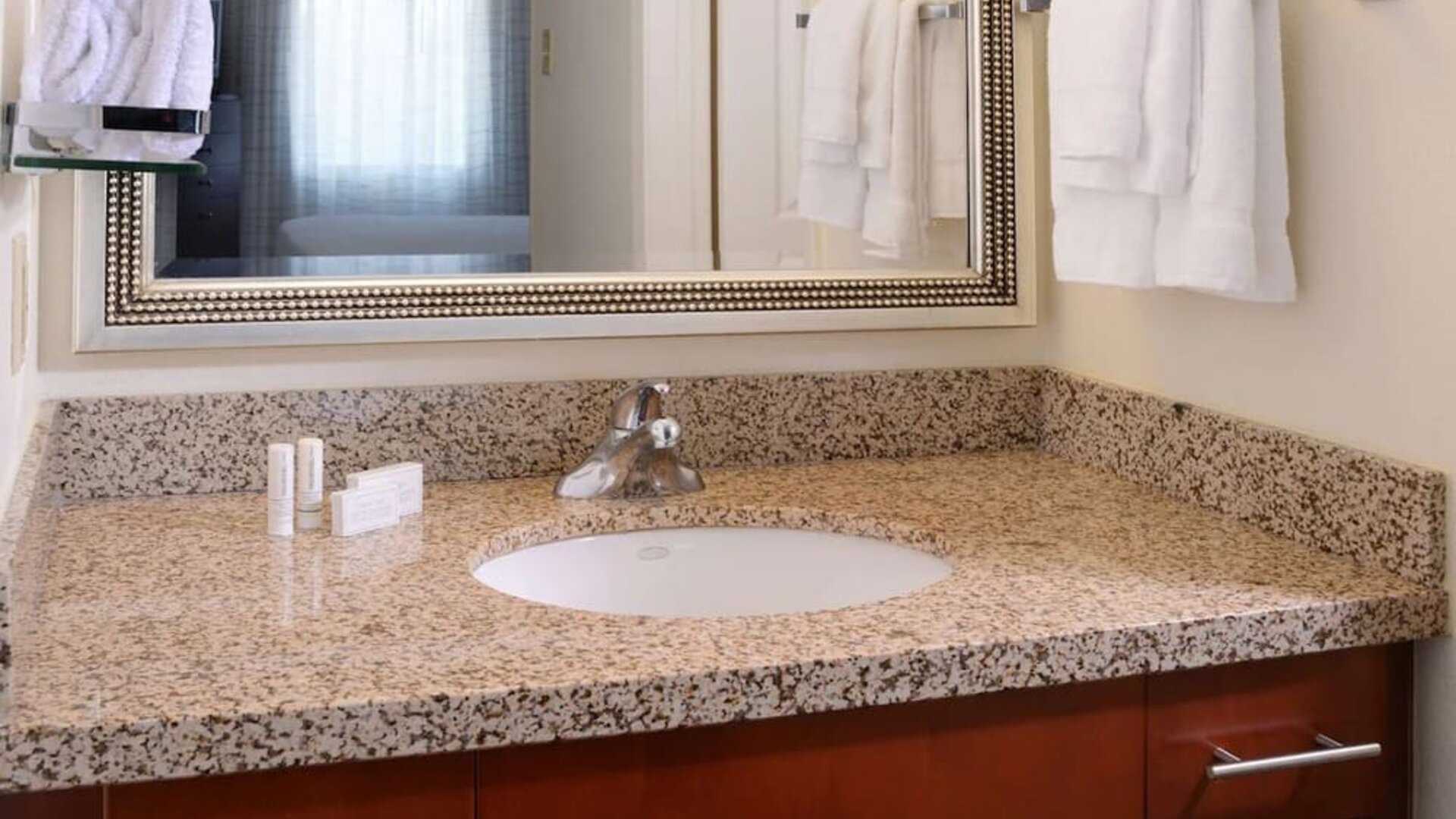 Private guest bathroom with shower and free toiletries at Sonesta ES Suites Dallas Medical Market Center.