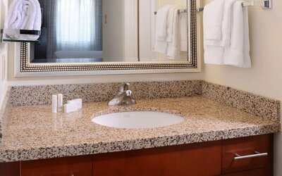 Private guest bathroom with shower and free toiletries at Sonesta ES Suites Dallas Medical Market Center.