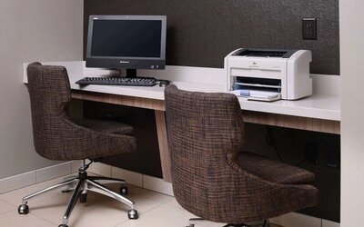 Business center with computer, printer and comfortable seating at Sonesta ES Suites Dallas Medical Market Center.