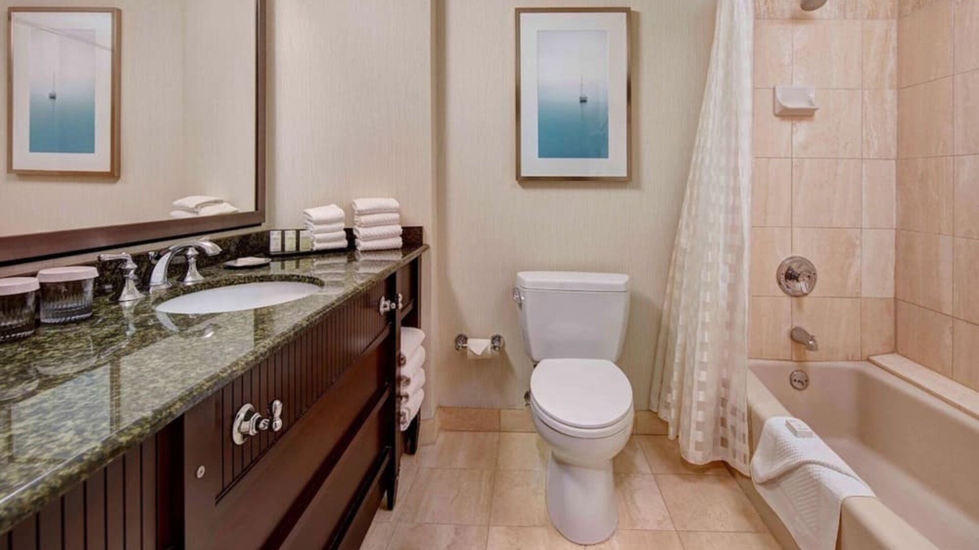 Guest bathroom with shower and tub at Embassy Suites By Hilton San Diego-La Jolla.