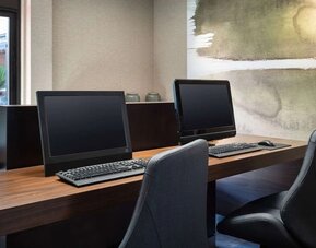 Business center with computers and ergonomic chairs at Sonesta Select Phoenix Camelback.