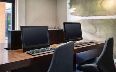 Business center with computers and ergonomic chairs at Sonesta Select Phoenix Camelback.